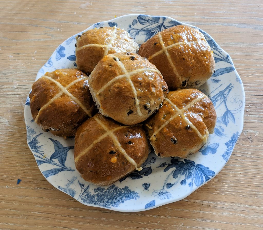 Fresh baked hot cross buns ready for buttering and eating
