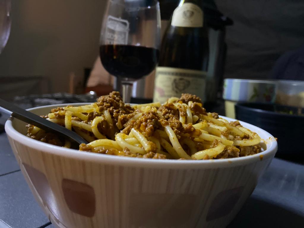 A bowl of Instant Pot Ragu enjoyed in a tent, hiding from the rain!