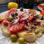 Tomato, onion and olive salad served on toasted bruschetta drizzled with olive oil and finished with grated parmesan cheese
