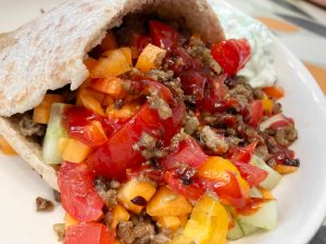 Minced steak kebabs in wholemeal pita with sriracha sauce